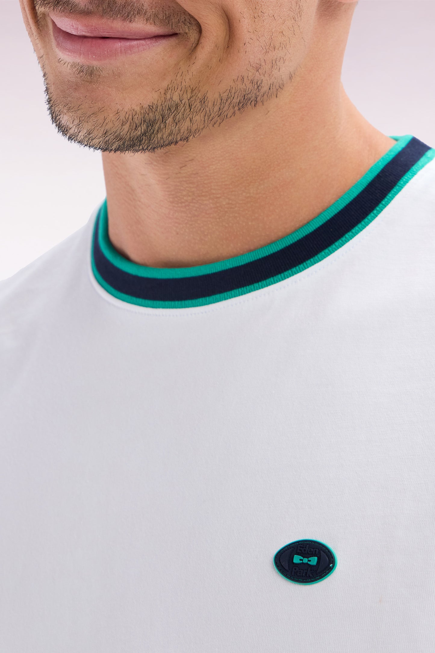 White cotton T-shirt with green ribbing, relaxed fit