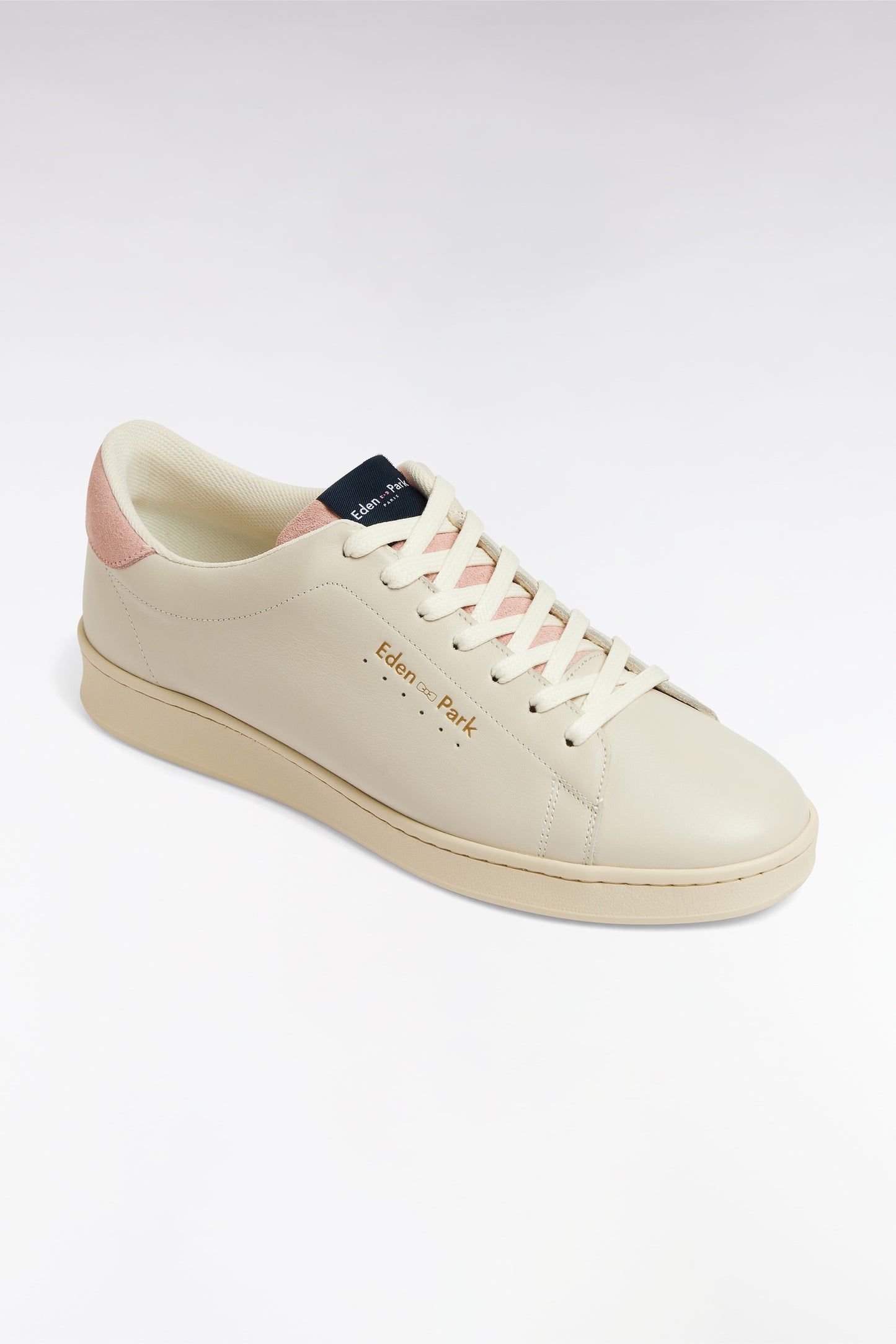 White leather low-top sneakers with pink accents