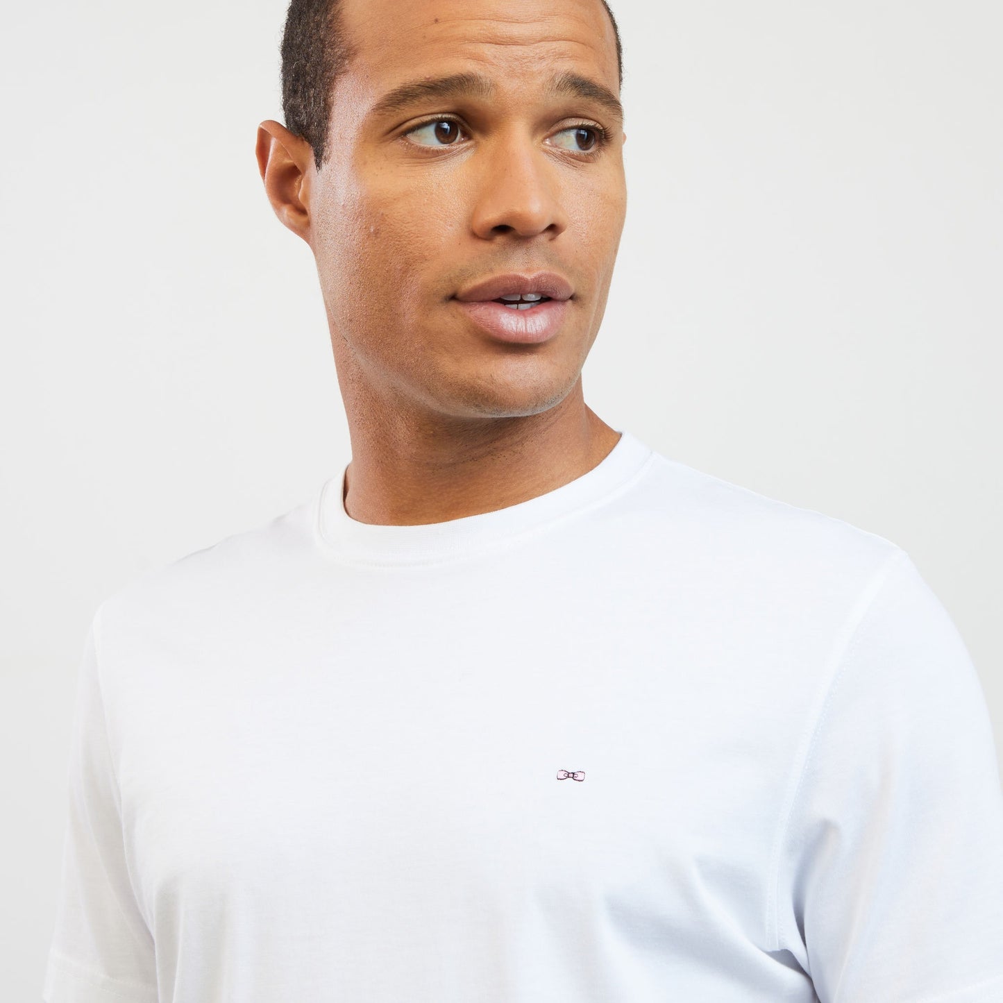 White T-shirt with embroidered bow tie on the back