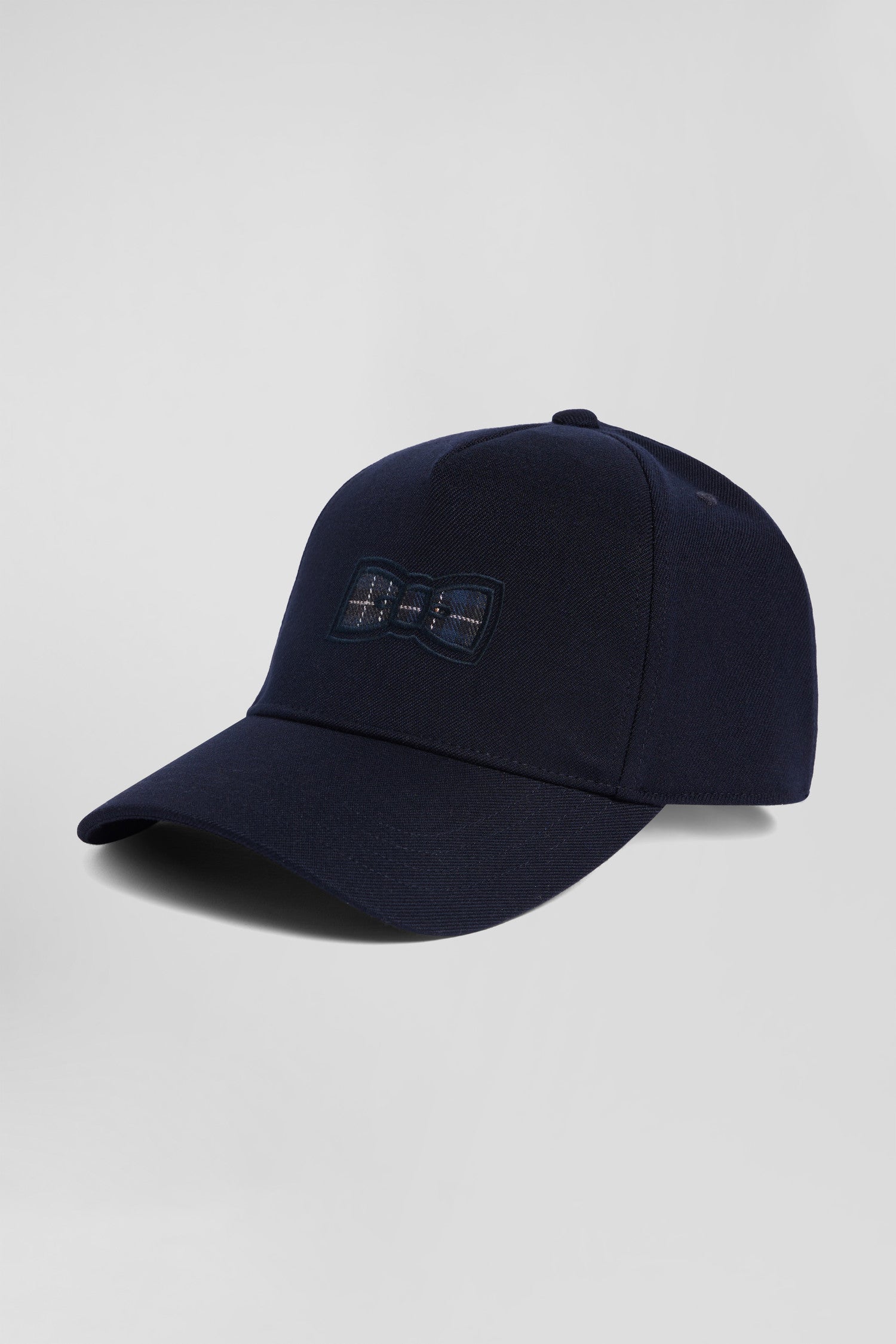 Navy blue cap with bow tie emblem