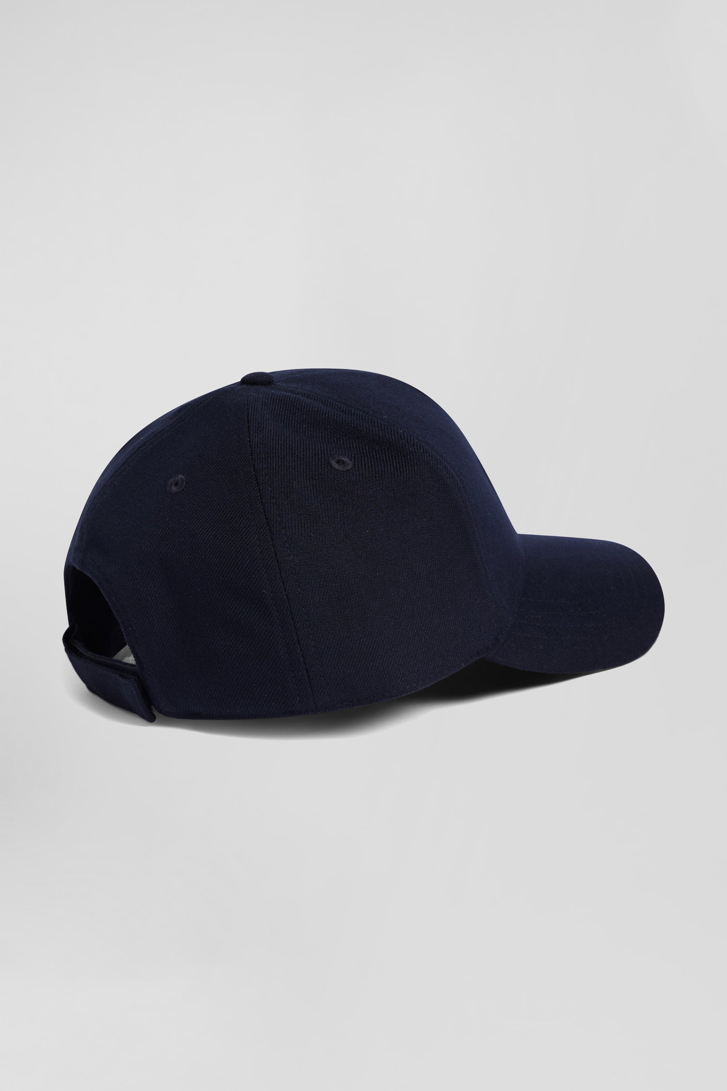 Navy blue cap with bow tie emblem