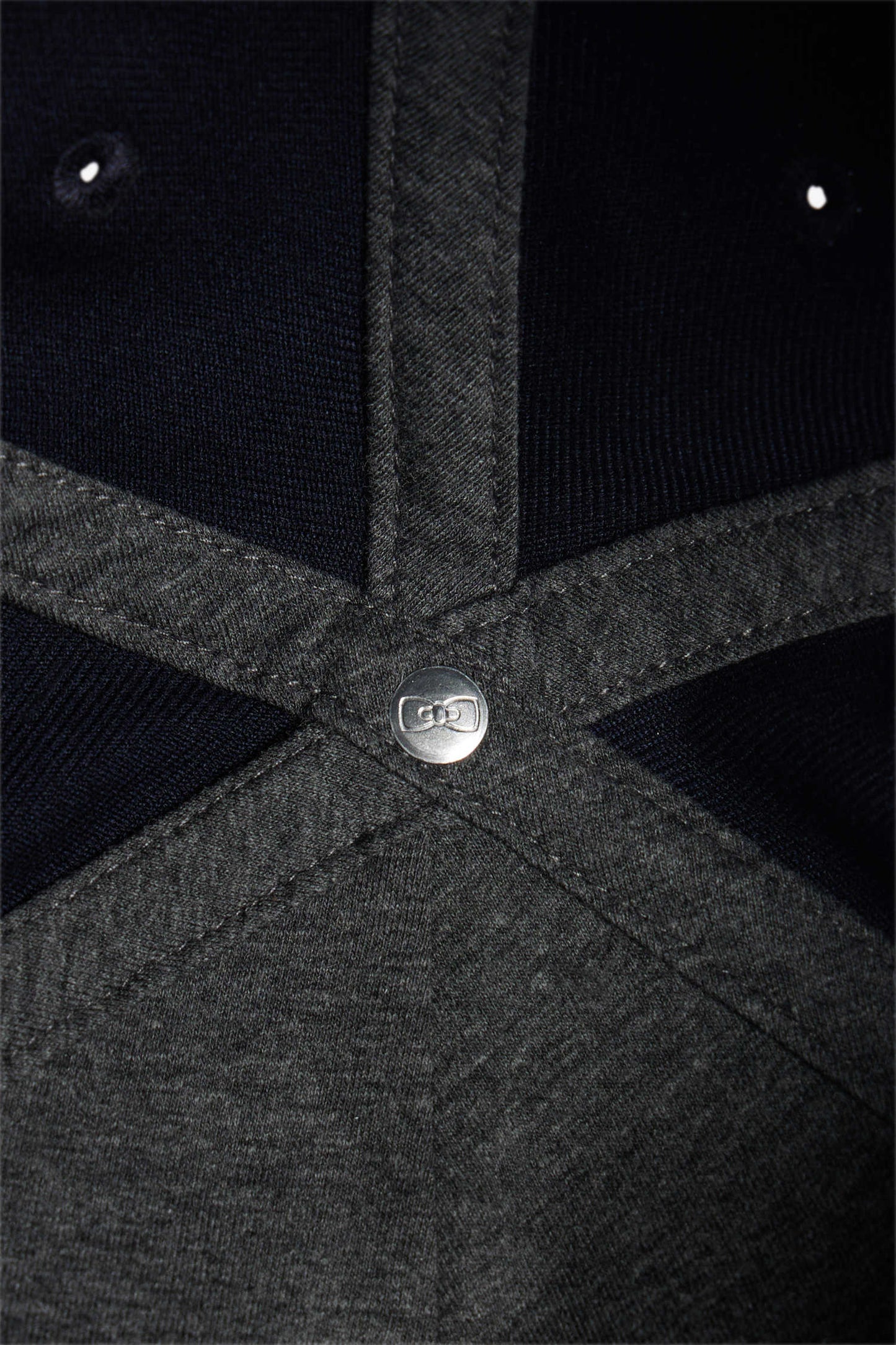 Navy blue cap with bow tie emblem