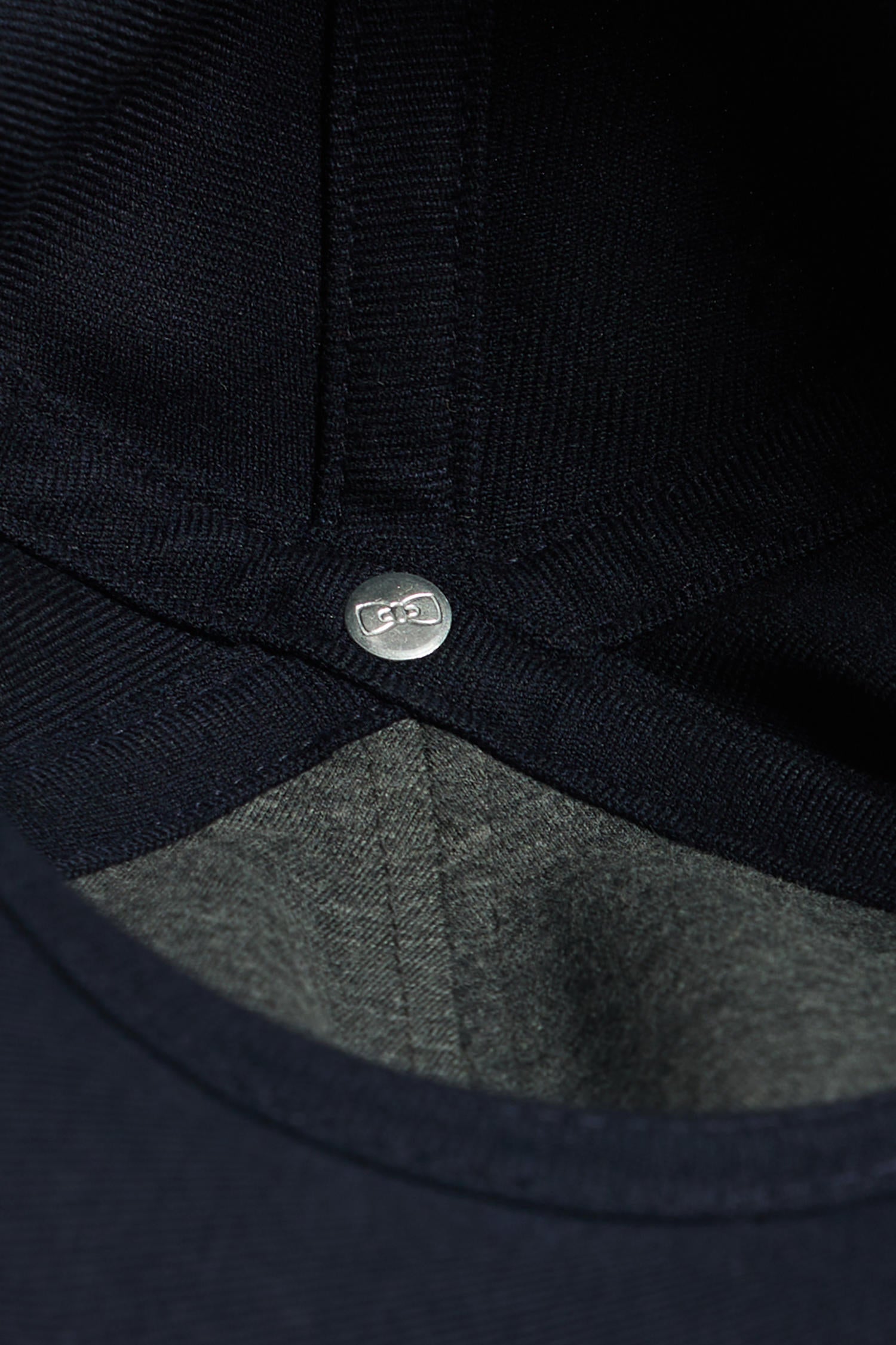 Navy blue cap with rubber badge and tricolour trim