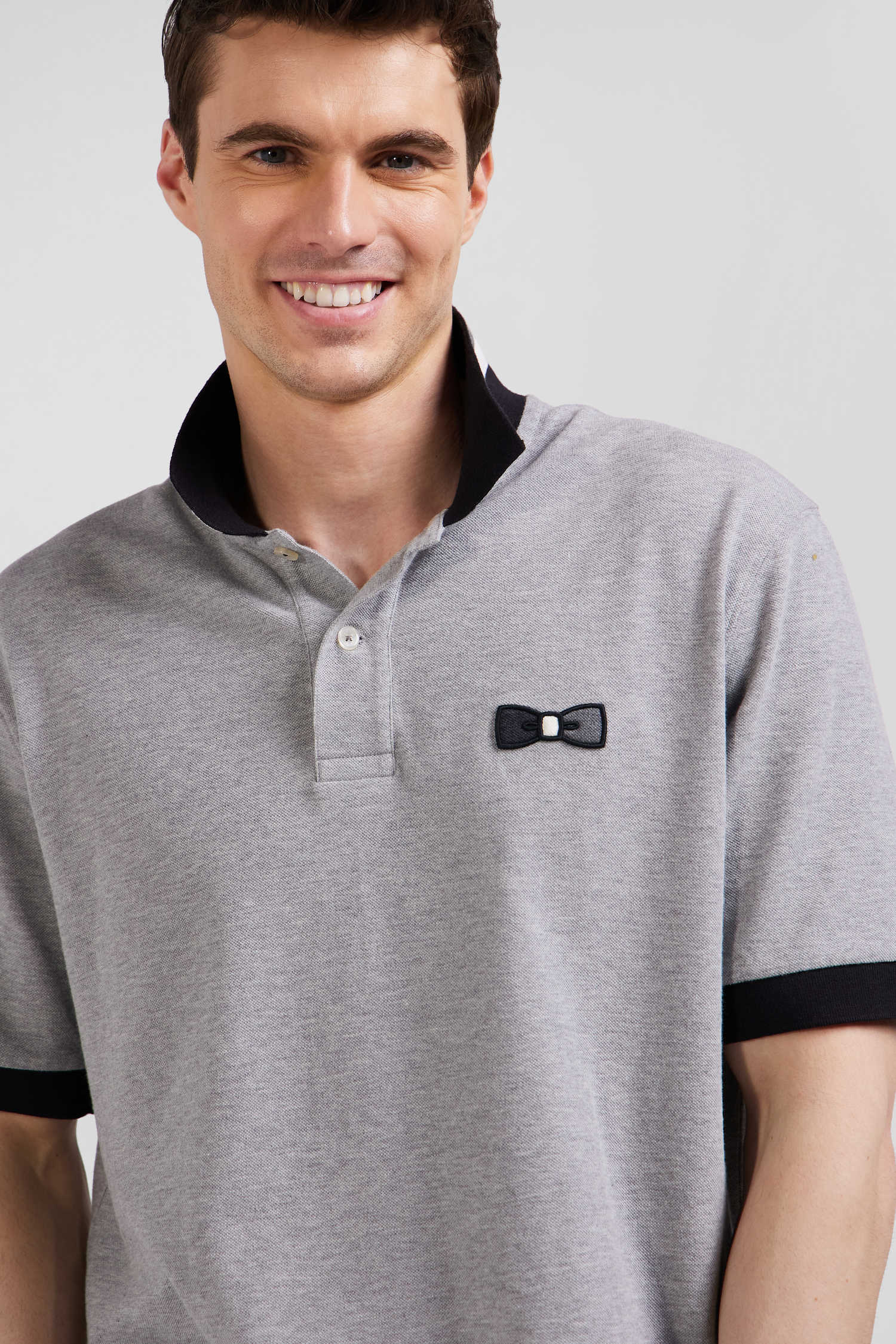 Oversize black short-sleeved cotton piqué polo shirt with tricolor details