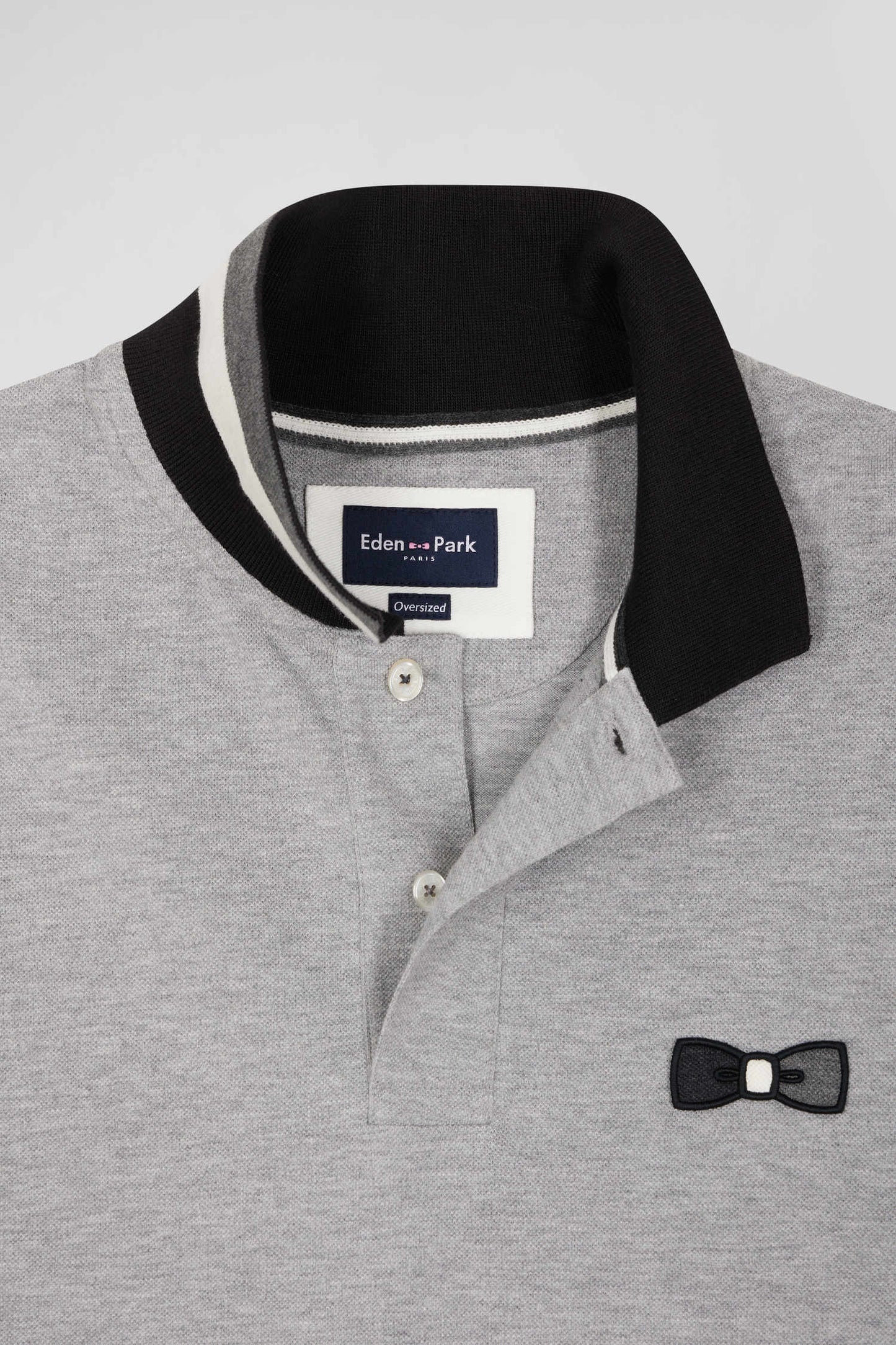 Oversize black short-sleeved cotton piqué polo shirt with tricolor details