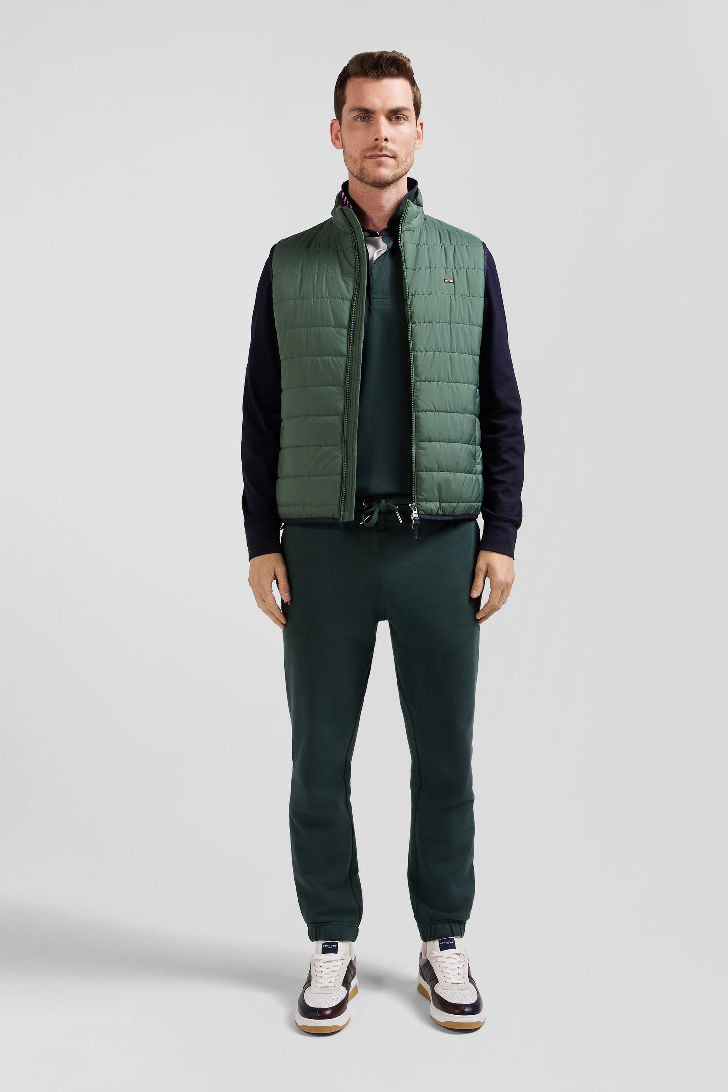 Green quilted sleeveless high collar down vest