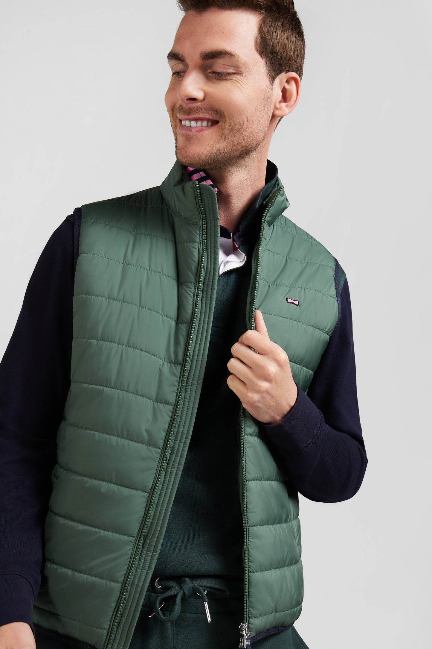 Green quilted sleeveless high collar down vest