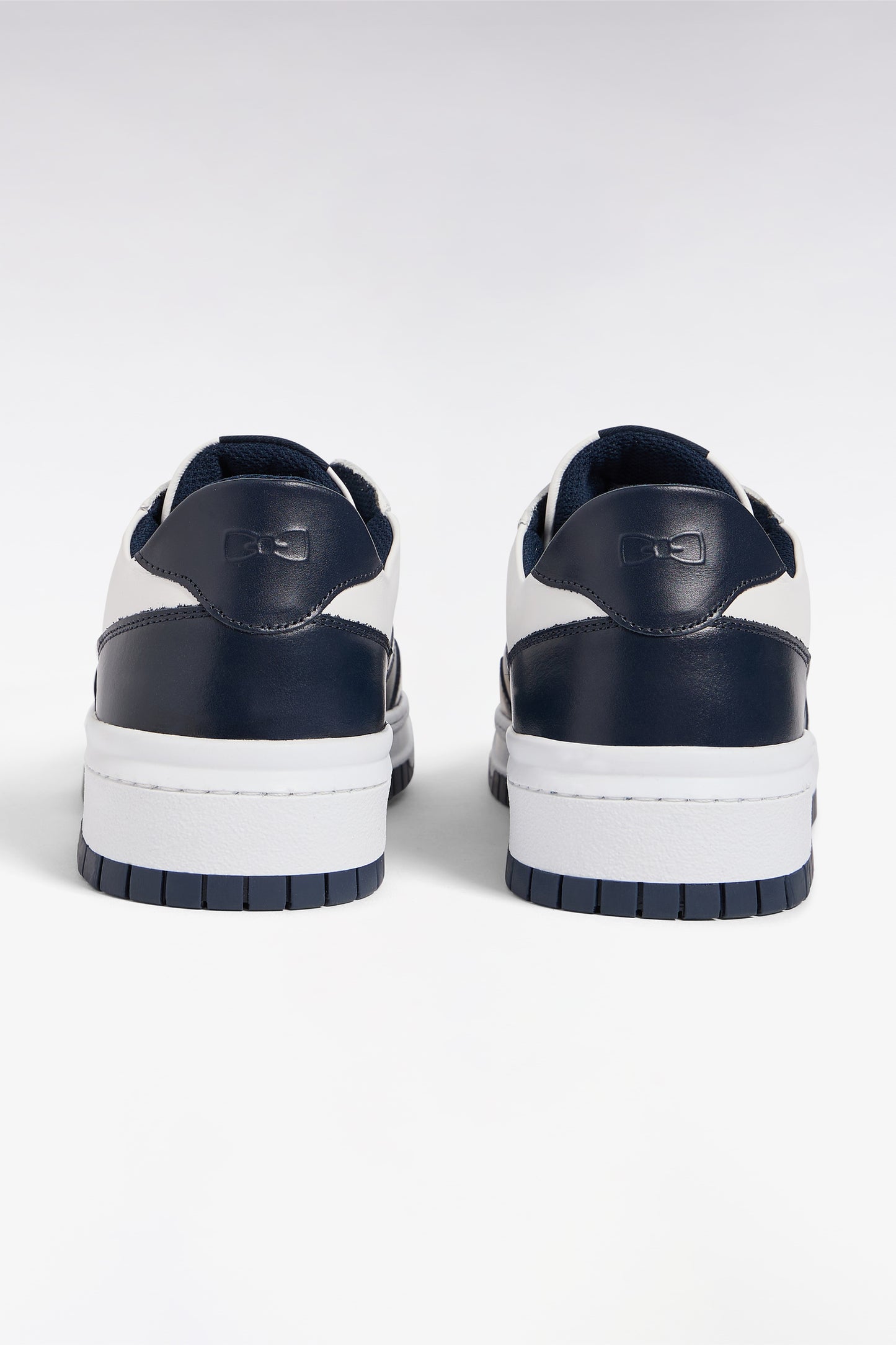 Two-tone navy and white leather sneakers