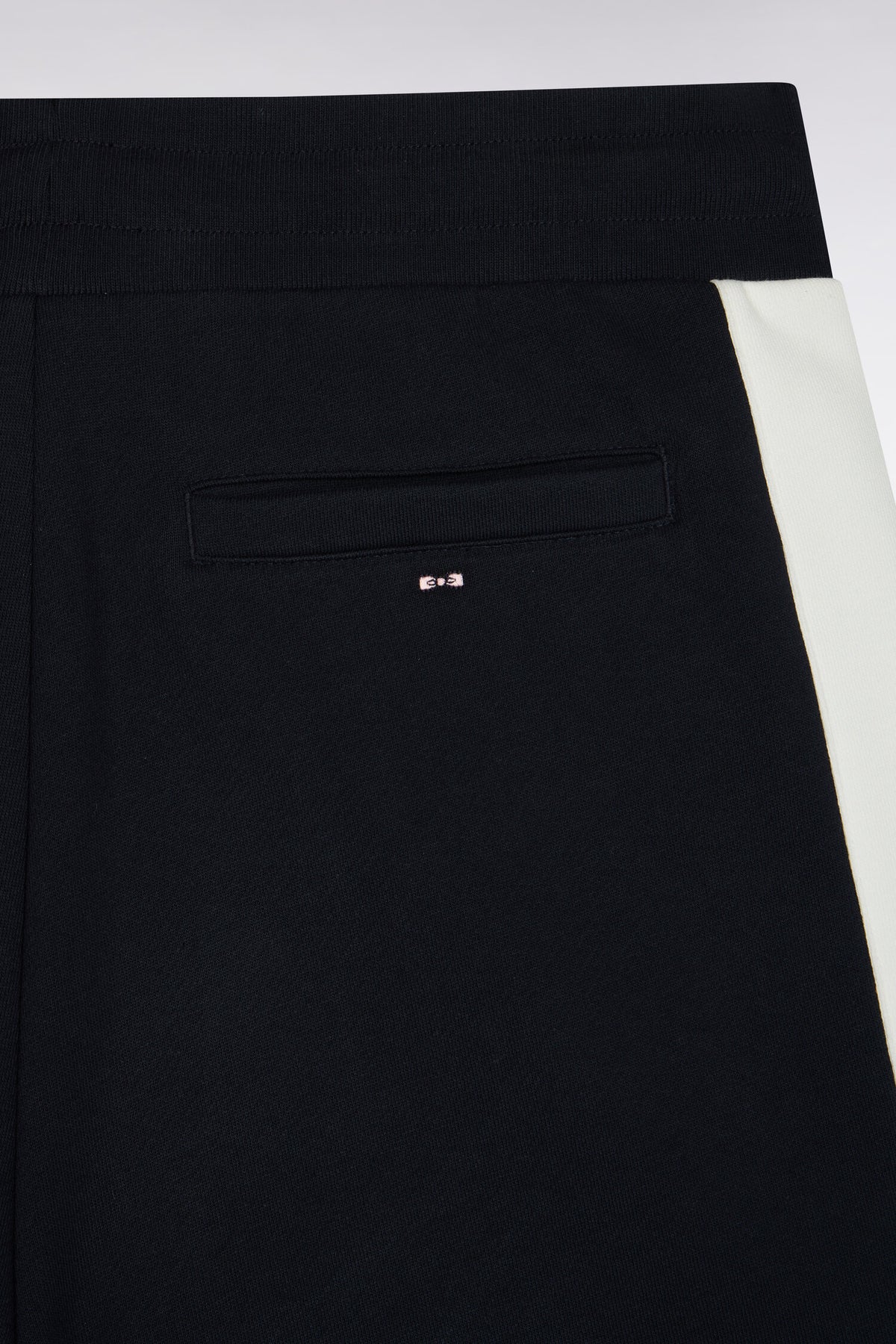 Navy fleece joggers with contrasting leg cutouts, straight cut