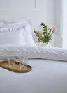 Comforter cover in white cotton percale with pink striped edging