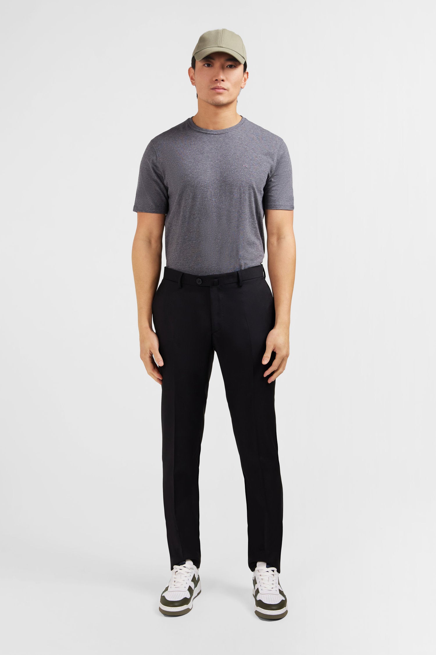 Slim black wool trousers with broken fold