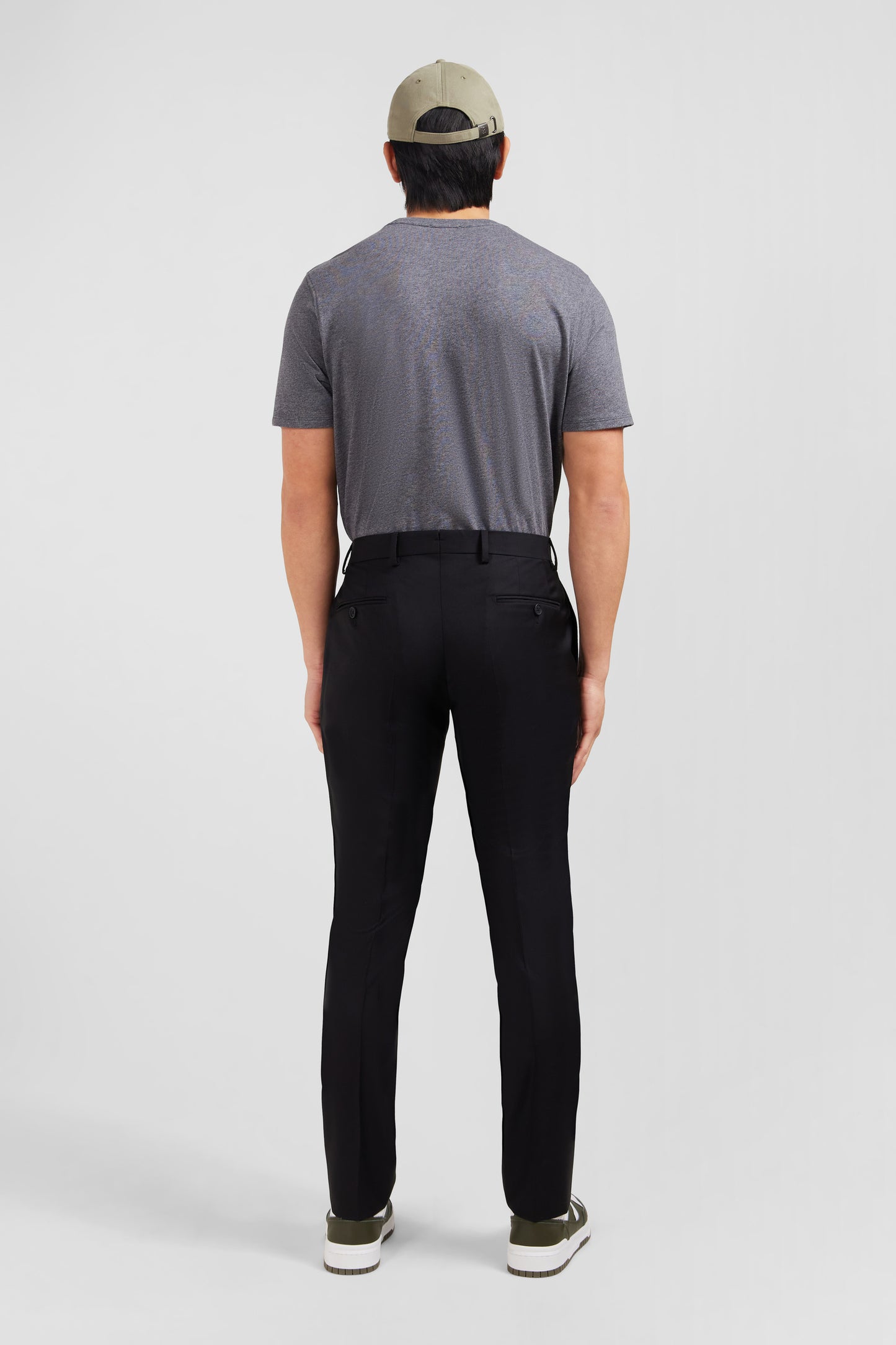 Slim black wool trousers with broken fold