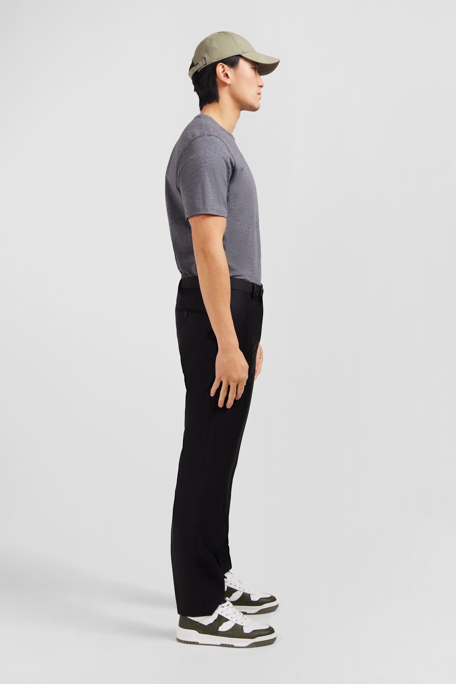 Slim black wool trousers with broken fold