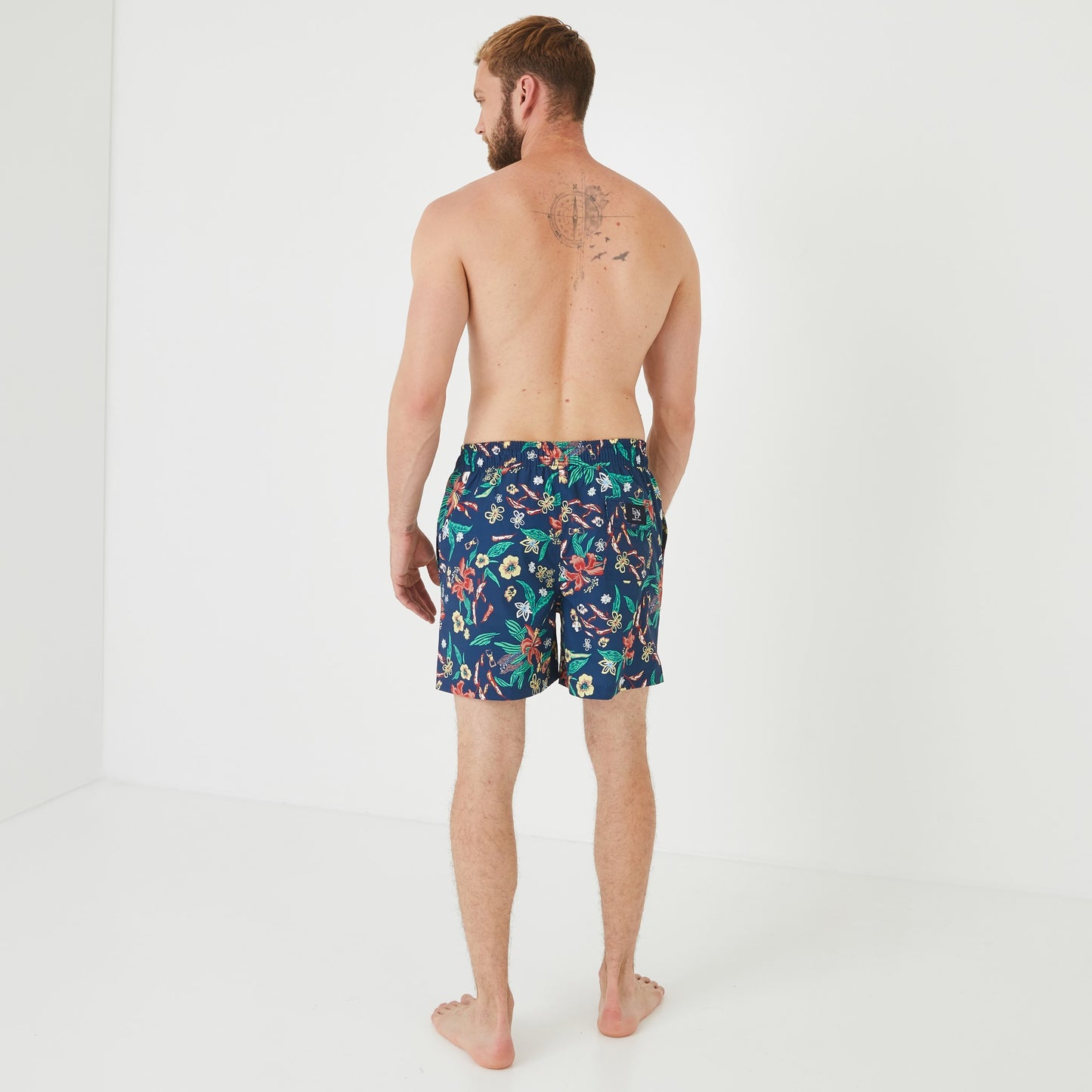 Navy blue swim shorts with floral pattern